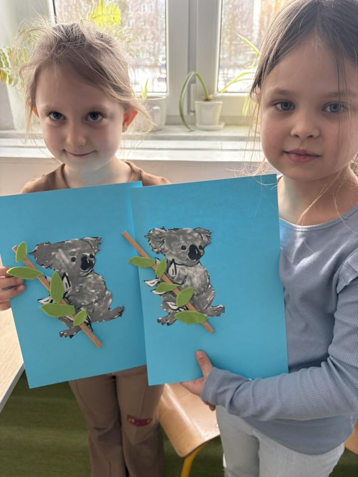 dziewczynki pokazują prace plastyczne- koala